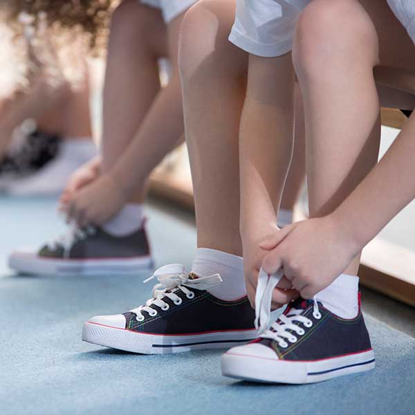Child tying shoes