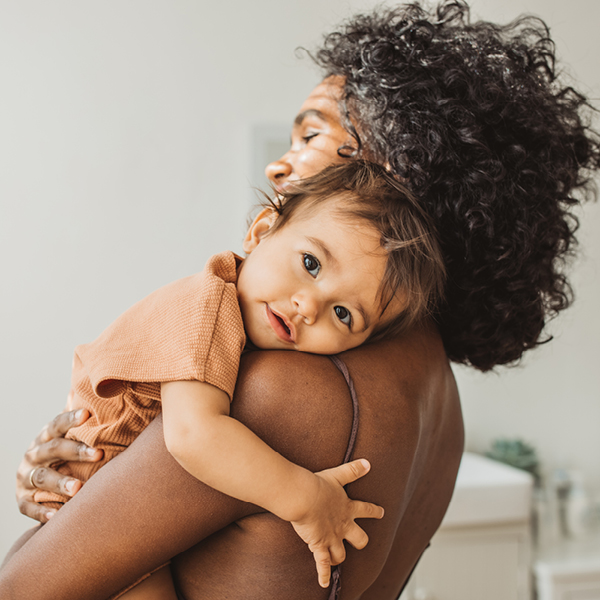 Mother holding her child side view