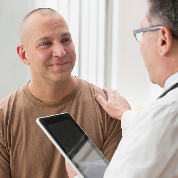 Man smiling with his doctor