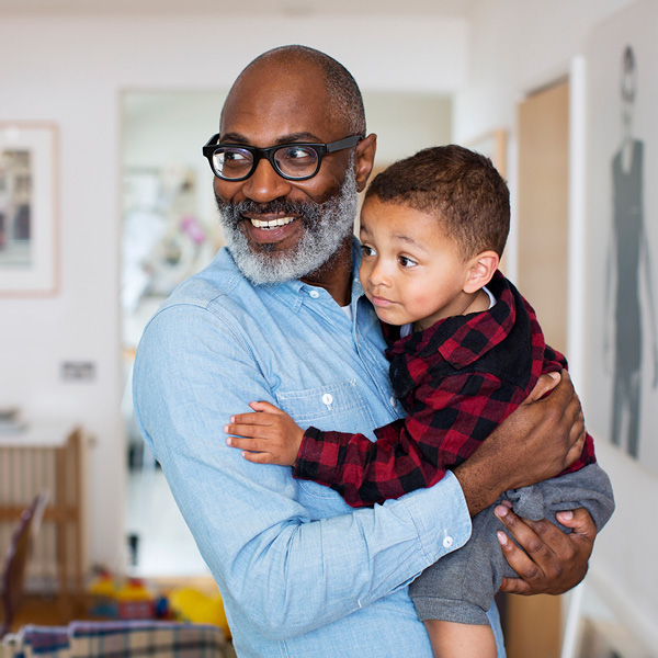 Smiling grandfather holding grandson