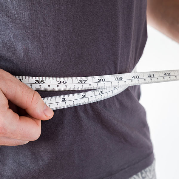 Man measuring his waist