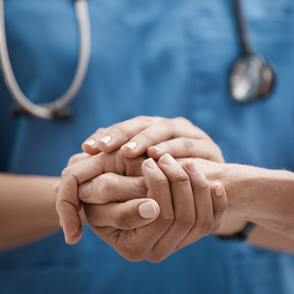 Doctor holding patient's hand