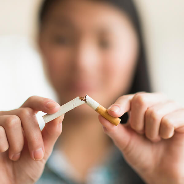 Woman breaking a cigarette