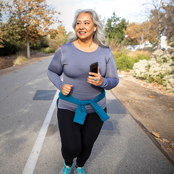 Woman jogging with her phone